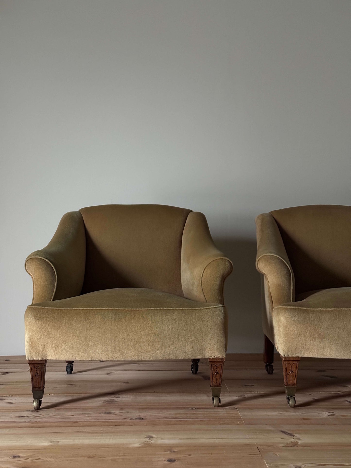 ON HOLD Pair of Edwardian armchairs on casters