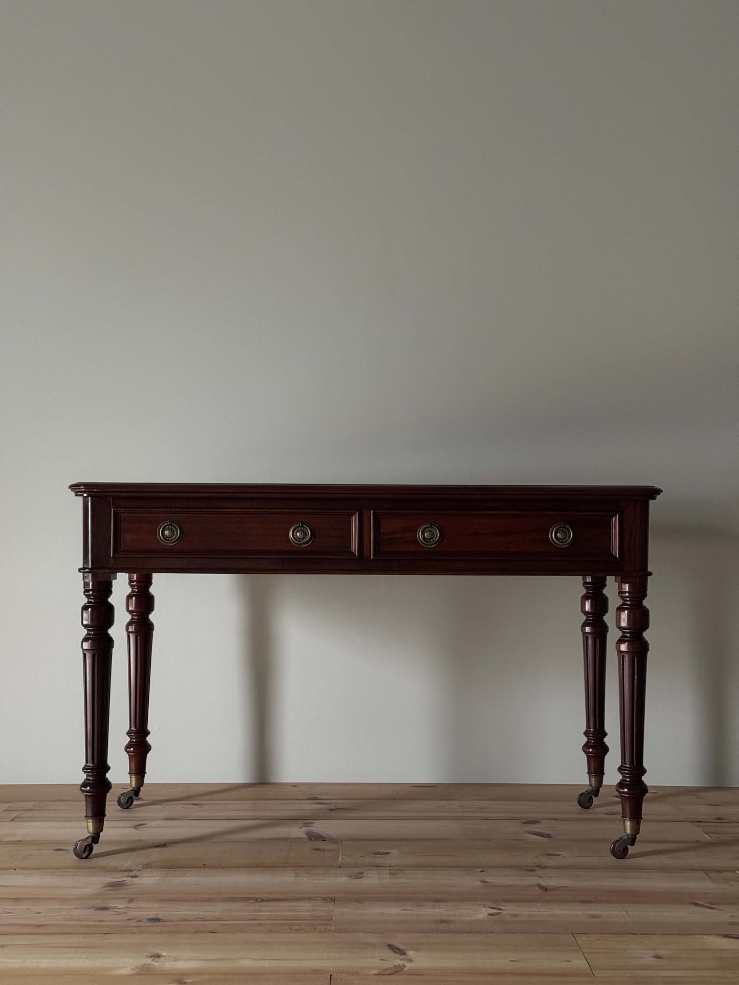 Antique desk on brass casters by James Shoolbred & Co