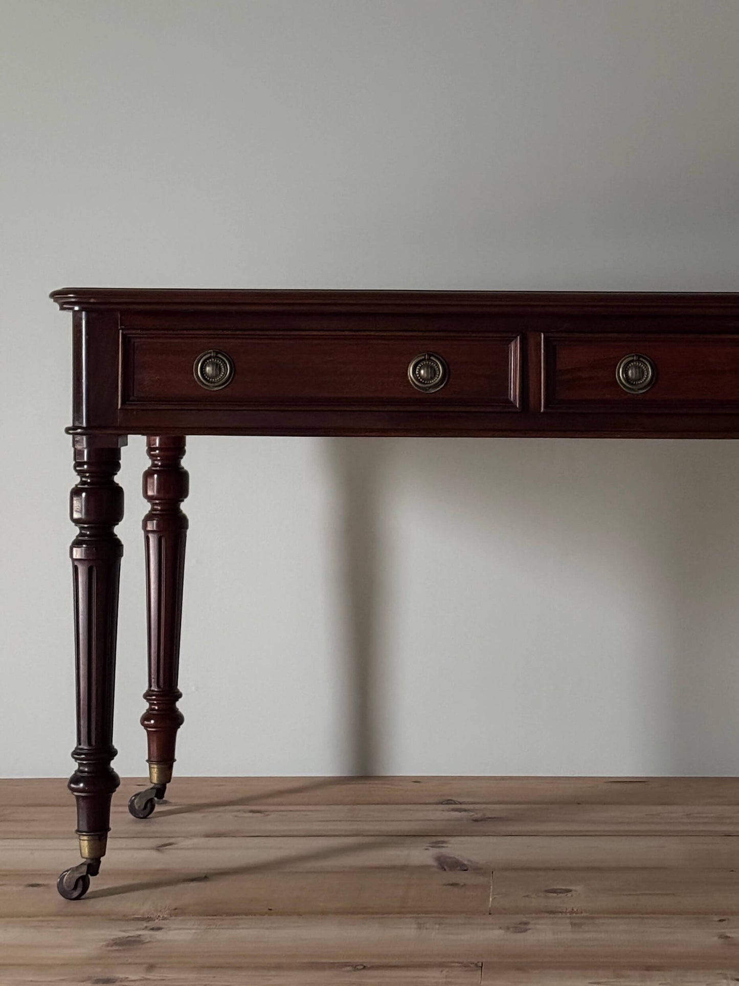 Antique desk on brass casters by James Shoolbred & Co