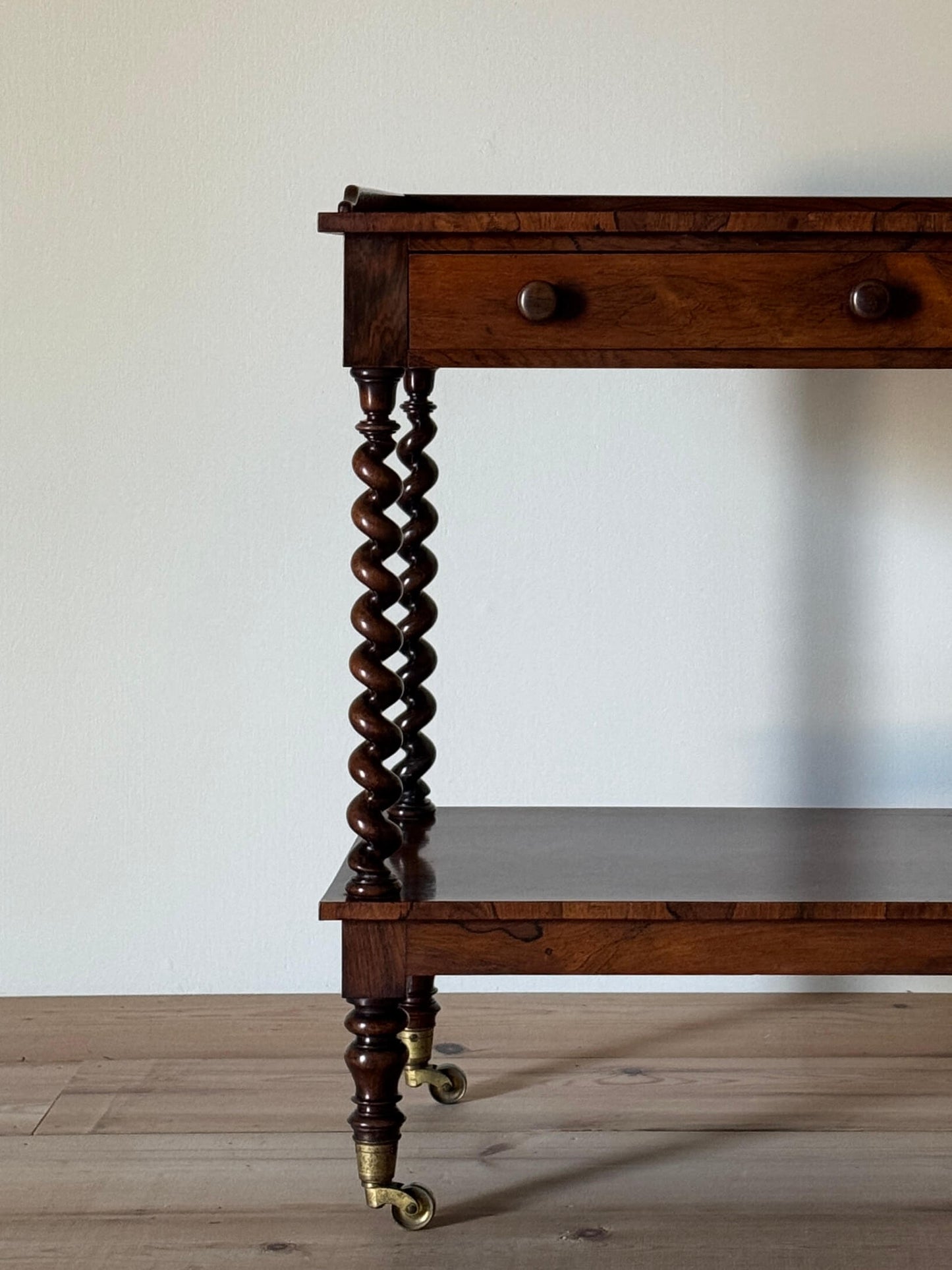 Early Victorian rosewood whatnot on castors
