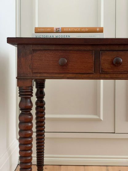 Antique bobbin console table on brass casters