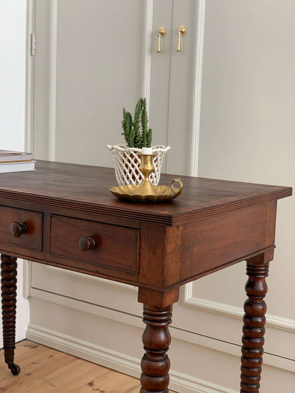 Antique bobbin console table on brass casters