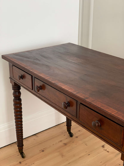 Antique bobbin console table on brass casters