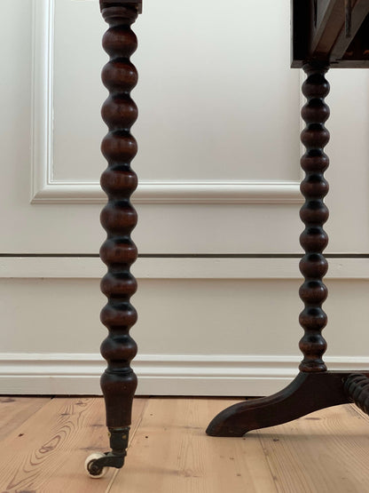 Antique bobbin drop-leaf table with casters