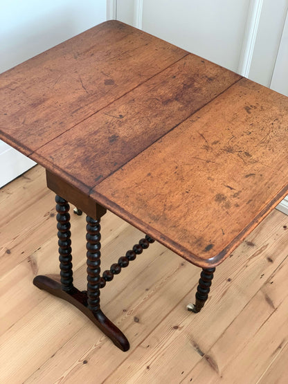 Antique bobbin drop-leaf table with casters