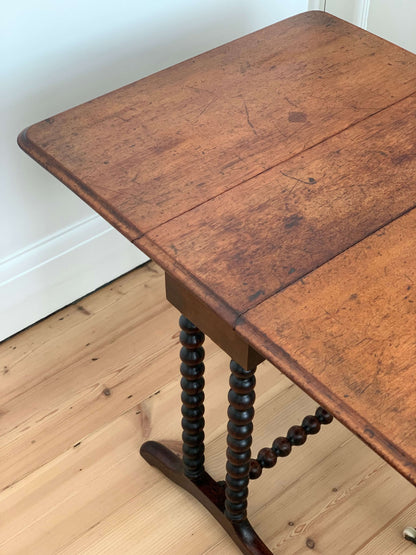 Antique bobbin drop-leaf table with casters